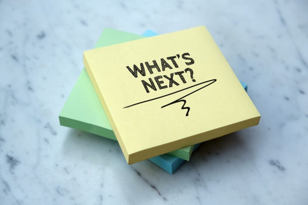 stack of post it notes with "What Next?" written on the top stack